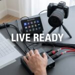 Live broadcast setup with Stream Deck, camera, and audio gear.